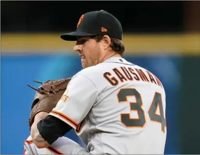  ?? ELAINE THOMPSON — THE ASSOCIATED PRESS ?? Giants starting pitcher Kevin Gausman throws against the Seattle Mariners on April 1, in Seattle.