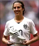  ??  ?? The boot-iful game: Carli Lloyd with her player of the tournament award