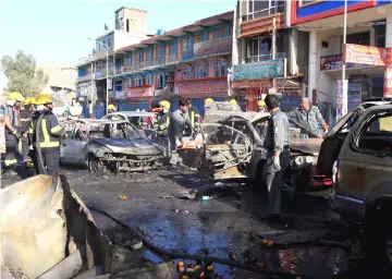  ?? — Reuters photo ?? Afghan policemen inspect the site of a blast in Jalalabad city, Afghanista­n.