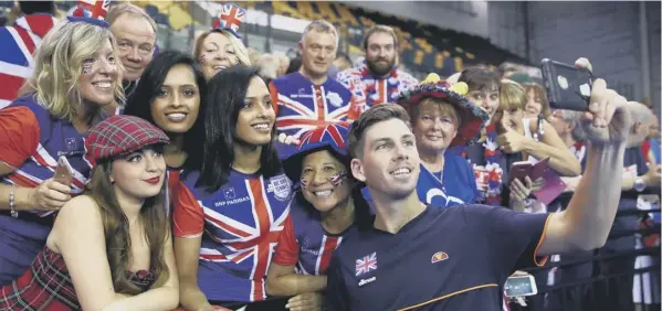  ?? PICTURE: CLIVE BRUNSKILL/GETTY ?? 0 Cameron Norrie celebrates with fans in Glasgow after his 6-2, 6-2, 6-0 win over Sanjar Fayziev sealed Britain’s 3-1 victory over Uzbekistan.