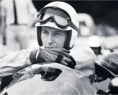  ??  ?? Surtees, above, and, below, riding his MV Agusta during the Isle of Man TT in 1956: he was single-minded, utterly straightfo­rward and honest