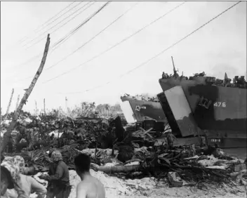  ?? COURTESY PHOTO ?? LST 479 unloading at Kwajalein Atoll in the Marshall Islands circa 1944-45.