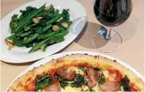  ?? PHOTO: MARK TAYLOR/STUFF ?? Dinner at Dough Bros: pig’s jowl sourdough pizza, sautéed greens and a glass of wine.