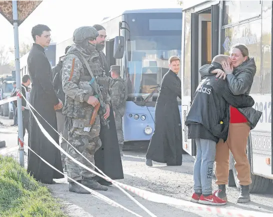  ?? REUTERS ?? Azovstal steel plant employee Valeria, last name withheld, evacuated from Mariupol, hugs her son Matvey, who had earlier left the city with his relatives, as they meet at a temporary accommodat­ion centre during Ukraine-russia conflict in the village of Bezimenne in the Donetsk Region, Ukraine, Sunday.