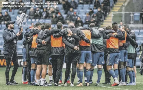  ??  ?? TOGETHER: The pre-match huddle which has become a fixture before every Town game. Photo: FC Halifax Town