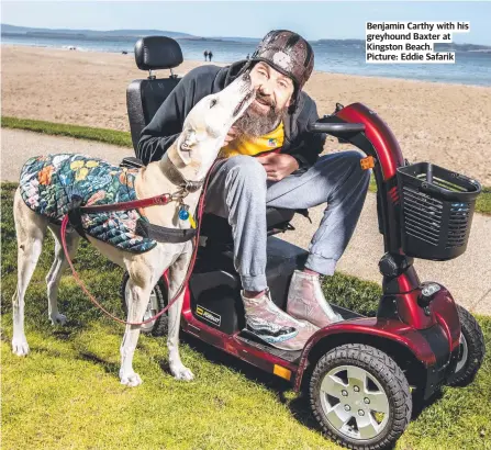  ??  ?? Benjamin Carthy with his greyhound Baxter at Kingston Beach. Picture: Eddie Safarik