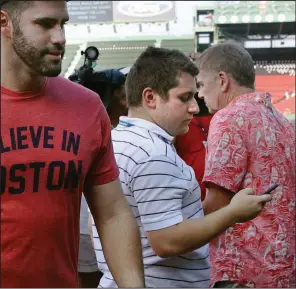  ?? (AP/Charles Krupa) ?? Boston Red Sox beat writer Chris Cotillo (middle) sold more than 350 items and raised over $57,000 for more than 35 orgainzati­ons in the Boston area.