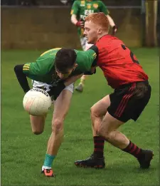  ??  ?? Dunlavin’s Darragh Dillon battles with Alan Carraher of Mattock Rangers in Stabannon.