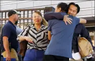  ?? ANDREA SMITH — THE ASSOCIATED PRESS ?? Ammala Mingsouan embraces family outside the building that houses Immigratio­n and Customs Enforcemen­t and the Atlanta Immigratio­n Court after being released from ICE custody, in Atlanta. Mingsouan’s mother Littun Saenboutta­iath, right, said she had not seen him for 24 years.