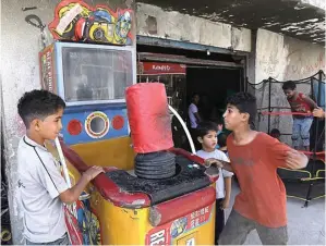  ?? AMMAR AWAD/ REUTERS ?? HIDUP YANG SUSAH: Anak-anak bermain di sebuah wahana di Amman, Jordania.