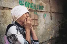  ?? GEORGE IVANCHENKO/ASSOCIATED PRESS ?? An elderly Ukrainian woman reacts to Russian shelling in Mykolaiv. American intelligen­ce believes the war will turn into a “grinding struggle.”