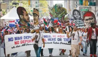  ?? (File Photo/AP/Bebeto Matthews) ?? A group calling for the end of deportatio­ns marches Aug. 13, 2017, in the Dominican Day Parade in New York. A new report released Monday by Pew Research Center says about 6 million adults in the United States identify as Afro Latino, a distinctio­n with deep roots in colonial Latin America.