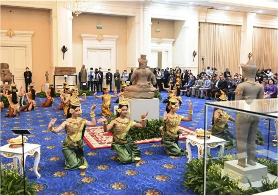  ?? KOK KY — CAMBODIA’S GOVERNMENT CABINET VIA AP ?? In this photo provided by Kok Ky/cambodia’s Government Cabinet, dancers perform during an handing over ceremony at Peace Palace, in Phnom Penh, Cambodia, Friday, March 17, 2023. Centuries-old cultural artifacts that had been illegally smuggled out from Cambodia were welcomed home Friday at a celebratio­n led by Prime Minister Hun Sen, who offered thanks for their return and appealed for further efforts to retrieve such stolen treasures.