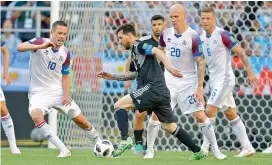  ?? AP ?? Argentina captain Lionel Messi (centre) tries to get past Iceland players during their Group ‘D’ match at the Spartak Stadium in Moscow on Saturday. —