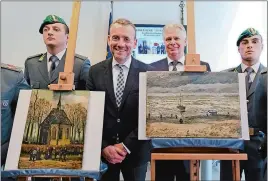  ?? CIRO FUSCO/ANSA VIA AP ?? Director of Amsterdam’s Van Gogh Museum Alex Rueger, center, stands next to the paintings “Congregati­on Leaving The Reformed Church of Nuenen,” left, and “Seascape at Schevening­en” by Vincent Van Gogh during a press conference in Naples, Italy, on...