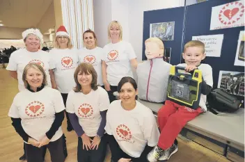  ??  ?? Deborah Slator (front left) with the Defibrilla­tors for All team at a Christmas fair