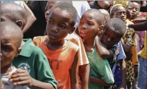  ?? (AP/Odelyn Joseph) ?? Children line up to receive a plate of food at a shelter for families displaced by gang violence in Port-au-Prince, Haiti, on Thursday.