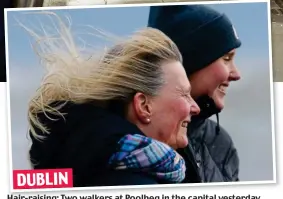  ?? ?? DUBLIN Hair-raising: Two walkers at Poolbeg in the capital yesterday