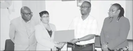  ??  ?? Ministry of Education Permanent Secretary shakes hands with GTU President Mark Lyte after the signing of the agreement on salary and non-salary benefits for teachers as Chief Education Officer Marcel Hutson and GTU General Secretary Coretta McDonald look on.