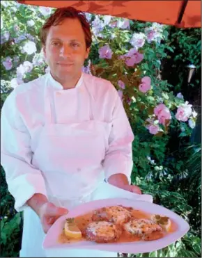  ?? Freeman photos by Tania Barricklo ?? ABOVE: Adam Monteverde, chef at the Puccine Ristorante, holds a plate of veal saltimboca, which translates literally as ‘jump in the mouth.’ BELOW: A plate of veal saltimboca is shown.