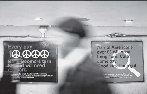  ?? PHILIP SCOTT ANDREWS / THE NEW YORK TIMES ?? Advertisem­ents last year in Washington’s Union Station endorsed cuts in Medicare and Medicaid. If behaviors change and costs continue to slow, then the deficit might go down.