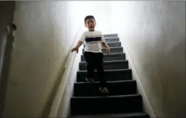  ?? GREGORY BULL — THE ASSOCIATED PRESS ?? Franco Perez cries as he runs downstairs from his family’s apartment in Covington, Ky., on April 28, 2018, looking for his father, Edgar Perez Ramirez, who had walked outside for a moment. Months after U.S. Immigratio­n and Customs Enforcemen­t agents arrested his father, the 4-year-old still shows more aggression toward his classmates and panics if his father leaves him for more than a few minutes.