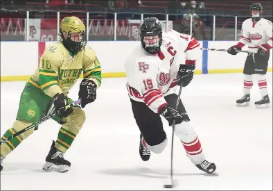  ?? Erik Trautmann / Hearst Connecticu­t Media ?? Notre Dame-West Haven’s John D'Errico, left, defends against Fairfield Prep’s Mason Whitney during Saturday’s game at Winterland Ice Rink in Bridgeport. The third-ranked Jesuits beat the top-ranked Green Knights 4-2. Get a full recap at GameTimeCT.com.