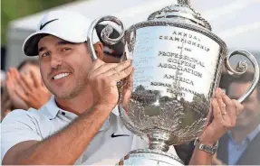  ?? SHAWN DOWD/ROCHESTER DEMOCRAT AND CHRONICLE ?? Brooks Koepka accepts the Wanamaker Trophy after his 2023 PGA Championsh­ip win at Oak Hill Country Club.