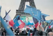  ?? ?? Above, Marine Le Pen stays positive. Left, Mr Macron’s supporters gather at the Eiffel Tower on Sunday to celebrate the president’s victory