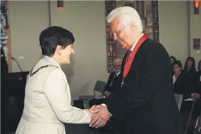  ?? PHOTO: GETTY IMAGES ?? Mum would be proud . . . GovernorGe­neral Dame Patsy Reddy congratula­tes Sir John Rowles after he received his knighthood at an investitur­e ceremony at Government House in Auckland yesterday.