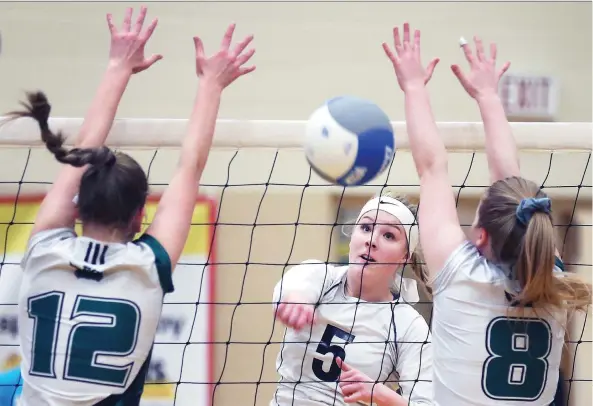  ?? DAN JANISSE ?? Emery Lucier of General Amherst spikes through two Ottawa Franco-Cite players during their OFSAA girls’ AA volleyball quarter-final match on Tuesday.