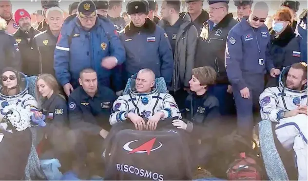  ?? Agence France-presse ?? Roscosmos cosmonaut Oleg Novitskiy (C), actress Yulia Peresild (L) and film director Klim Shipenko rest in chairs after landing in Zhezkazgan, Kazakhstan.