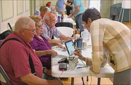  ?? Lori Van Buren / Times Union ?? Leslie Boyer of Albany, right, signs in to vote during a primary at The Ancient Order of Hibernians on Tuesday in Albany. Many races for Common Council seats in the city drew lower voter turnout than in years past.