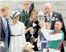  ?? Photo / AP ?? The Duke and Duchess of Sussex, left, present the St James’s Palace trophy to Frankie Dettori.