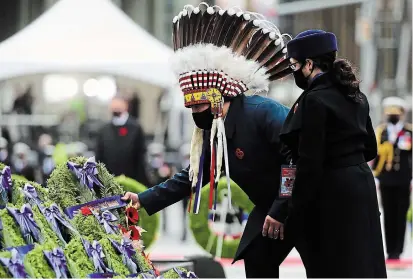  ?? SEAN KILPATRICK THE CANADIAN PRESS ?? National Chief of the Assembly of First Nations Perry Bellegarde places a wreath as he takes part in the Remembranc­e Day ceremony at the National War Memorial in Ottawa on Wednesday.