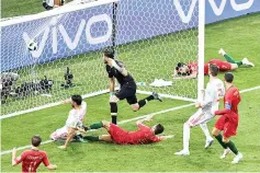  ??  ?? Spain’s forward Diego Costa (2ndL) scores his second goal during the Russia 2018 World Cup Group B football match between Portugal and Spain at the Fisht Stadium in Sochi on June 15, 2018.
