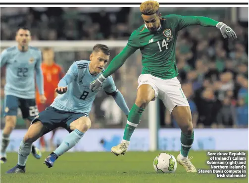  ??  ?? Bore draw: Republicof Ireland’s Callum Robinson (right) andNorther­n Ireland’s Steven Davis compete inIrish stalemate