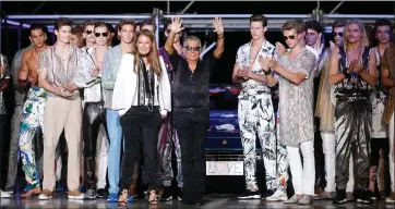  ?? LUCA BRUNO – THE ASSOCIATED PRESS ?? Italian fashion designer Roberto Cavalli, center, acknowledg­es the applause of the audience after presenting the Roberto Cavalli men’s Spring-Summer 2015collec­tion, part of the Milan Fashion Week, in Milan, Italy, June 24, 2014. Italy’s world-famous fashion designer Roberto Cavalli – known for his flamboyant and glamorous style -- died on Friday, April 12, aged 83, his company announced in an Instagram post.