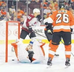  ?? TOM MIHALEK/ASSOCIATED PRESS ?? Philadelph­ia goalie Brian Elliott is down on the ice after a goal by Colorado’s Mikko Rantanen during the Flyers’ loss to the Avalanche Monday.