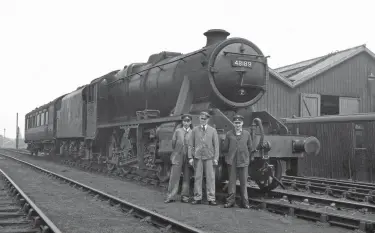  ?? C R L Coles/Rail Archive Stephenson ?? A Sheffield Grimesthor­pe (19A) engine when the exchange trials began, Stanier ‘8F’ 2-8-0 No 48189 is seen with the test crew and the ex-L&YR dynamomete­r car at Cricklewoo­d. The carriage and wagon depot provides the backdrop, with the Midland main line unseen on the far side of the building, as are the massive Brent sidings to the north, east and south of Cricklewoo­d shed, which itself is behind the photograph­er. Unlike Thompson ‘O1’ No 63773 and Churchward/Collett No 3803, the Stanier ‘8F’ is in far from pristine external condition – it is only just possible to read the British Railways number on the cab side-sheets and the LMS lettering on the tender. Like the other freight engines in the tests, No 48189’s performanc­es lacked consistenc­y, in part due to the numerous slacks encountere­d on all the routes, not least on the Midland between Toton and Brent yard, where the ‘8F’ was tested in the week beginning 28 June 1948, so that helps to date the view.