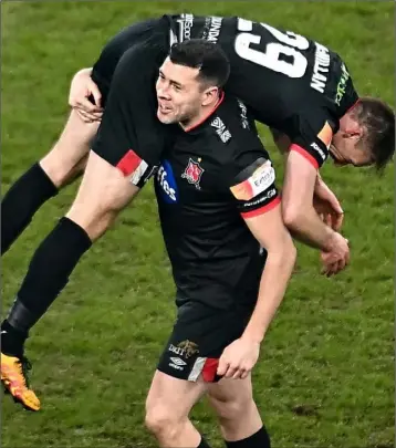  ??  ?? Happy days - Brian Gartland, pictured celebratin­g with David McMillan after the 2020 Extra.ie FAI Cup Final victory, will stay with Dundalk for at least another year.