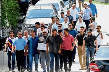  ??  ?? Showing their support: Razlan (fourth from left) and other supporters gathering at Najib’s residence at Langgak Duta, Taman Duta in Kuala Lumpur.