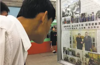  ?? Eric Talmadge / Associated Press ?? At a subway station in Pyongyang, North Korea, commuters read the news about North Korean leader Kim Jong Un’s arrival in Singapore for his summit with President Donald Trump.