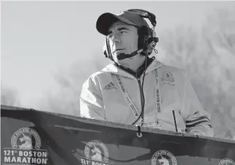  ?? [MARY SCHWALM/ASSOCIATED PRESS FILE PHOTO] ?? In this April 17, 2017, photo, race director Dave McGillivra­y looks on from the platform at the start of the 2017 Boston Marathon in Hopkinton, Mass.