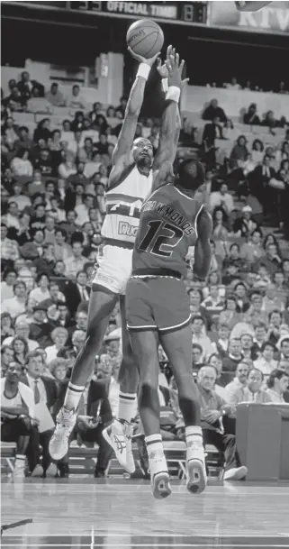  ?? Tim Defrisco, Getty Images file ?? The Nuggets’ Alex English shoots the ball over Tom Hammonds of the Washington Bullets at Mcnichols Sports Arena in 1989.