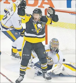  ?? AP PHOTO ?? Pittsburgh Penguins forward Jake Guentzel, front, celebrates a goal by teammate Evgeni Malkin during Monday’s Game 1 of the Stanley Cup Final.
