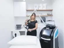  ??  ?? Medical estheticia­n Amra Nizar demonstrat­es a laser skin treatment offered at the clinic in Oakville, Ont.