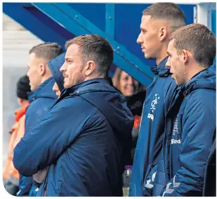  ??  ?? Andy Halliday, Nikola Katic and Jon Flanagan look on as the Ibrox ground staff did everything they could to make the pitch playable