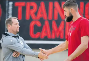  ?? —CP ?? Raptors head coach Nick Nurse shakes hands with Jonas Valanciuna­s during a team practice in Burnaby yesterday. Inset, Fred VanVleet wore a championsh­ip belt around his waist, having earned the light-hearted honour with his solid play in fiveon-five scrimmages.