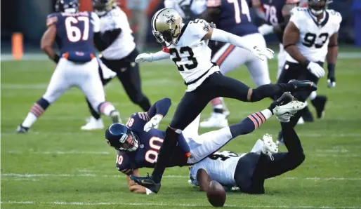  ??  ?? Saints safety Marcus Williams ( 43) and cornerback Marshon Lattimore break up a pass intended for tight end Jimmy Graham during the Bears’ loss to New Orleans.